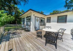a wooden deck with a table and chairs at Delightful 4 Bedroom Luxury House In Jacksonville in Jacksonville