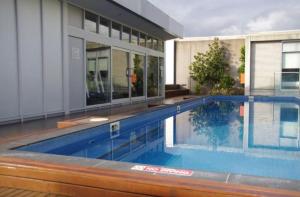 a swimming pool in front of a house at East Melb 2bed parking pet friendly in Melbourne