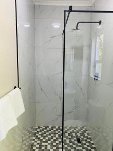 a shower with a glass door in a bathroom at Cozy Garden Facing Guest Suite -(Back up power) in Midrand