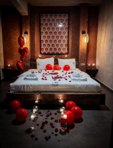 a bedroom with a bed with red balloons and red candles at MAVİ AT HOTEL Blue Horse in Gümüşdere