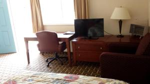 a room with a desk with a computer and a chair at Executive Inn & Suites in Lakeview