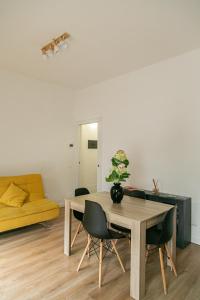 a living room with a table and chairs at Alla Fiera apartment in Bergamo