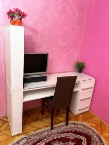 a white desk with a computer in a pink wall at Villa Old Town in Podgorica