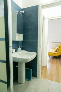 a bathroom with a sink and a blue wall at Alla Fiera apartment in Bergamo