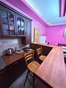 a kitchen with a wooden table and chairs at Villa Old Town in Podgorica