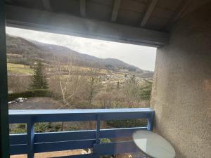 a balcony with a view of a mountain at Le Castel du Cantal Groupe Village Fani in Thiézac