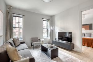 a living room with a couch and a bed at Brooklyn Heights 2br w elevator wd NYC-1066 in Brooklyn