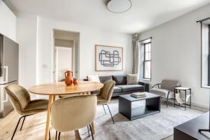 a living room with a table and chairs and a couch at Brooklyn Heights 2br w elevator wd NYC-1066 in Brooklyn