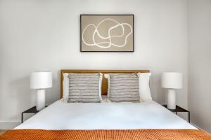 a bedroom with a bed with two lamps at Brooklyn Heights 2br w elevator wd NYC-1066 in Brooklyn