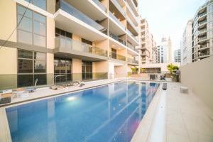 a swimming pool in the middle of a building at New Contemporary 1BR Apt in Jumeirah Garden City in Dubai