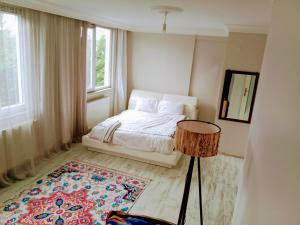 a white bedroom with a bed and a window at Villa closest to Istanbul airport in Arnavutköy