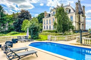 an estate with a swimming pool in front of a house at Chateau de Clinzeau in Saint-Léger-de-Fougeret