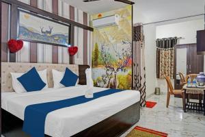 a bedroom with a large bed and a dining room at Hotel Viraj in Pune