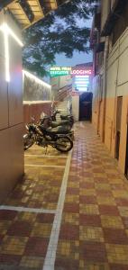 a row of motorcycles parked in a hallway at Hotel Viraj in Pune