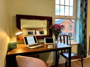 a desk with a laptop computer on top of it at The Lily•Central Beeston•Private Apartment•SmartTV•Free Wi-Fi•Tram• in Nottingham