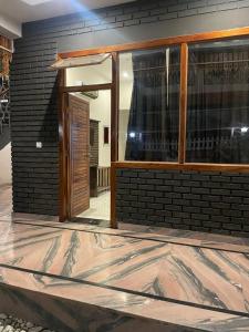 a house under construction with a door and a brick wall at The Farmerian Resort in Belparāo