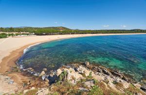 a view of a beach with people in the water at Bonòra Suites in Tortolì