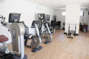 a gym with treadmills and exercise bikes in a room at Residence Bafjle 42 in Lido di Jesolo