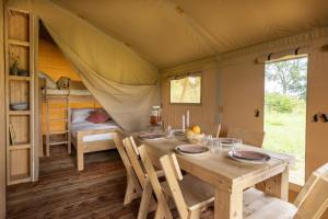 a dining room with a table in a tent at Il Castagno Toscana Glamping in Campiglia Marittima