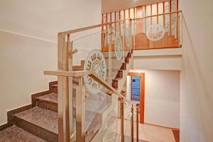 a staircase in a house with a glass railing at Super Townhouse 865 Edasserys Sea Pearl in Ernakulam