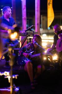 a woman sitting on a stage with a microphone at Bristol Sunset Beach - Holiday Apartments in Corralejo