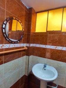 a bathroom with a sink and a mirror at Montafé Mirador in Tarma