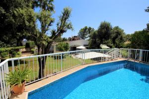 una piscina con una valla blanca y árboles en Casa Familia - House for 4, en Sa Pobla