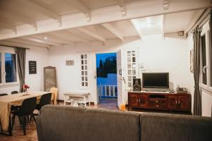 een woonkamer met een bank en een televisie bij Casita Montoya in Alhaurín de la Torre