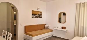 a bathroom with a bench and a mirror at Marianthi Studios in Áno Meriá