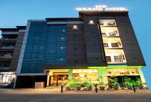 a tall building with a store in front of it at HR Grand Hotel in New Delhi