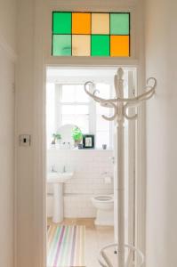a bathroom with a toilet and a stained glass window at Bright wood-floor apartment near Parliament in London