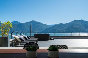 a balcony with chairs and a view of the mountains at Villa Navalia in Menaggio