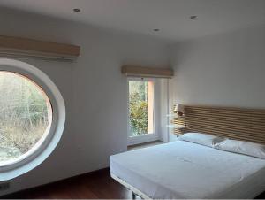 a bedroom with a bed and a large window at Hotel Spa La Central - Adults Only in Maçanet de Cabrenys