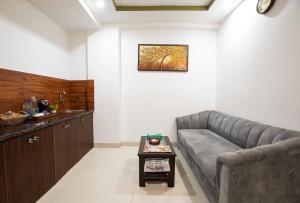 a living room with a couch and a table at HR Grand Hotel in New Delhi