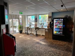 a soda shop with a soda machine in a store at Budget Trianon Hotel in Amsterdam