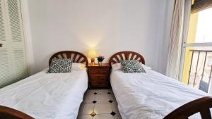 En eller flere senge i et værelse på AA Guest - Alcazaba del Jardín de Sierra Nevada
