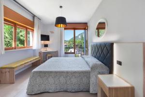 a bedroom with a bed and a window at Hotel Gabbiano - Garda Lake Collection in Garda