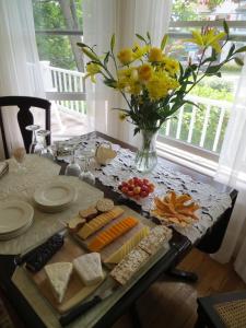 a table with food and a vase of flowers at Atlantic Ark Inn in Boothbay Harbor