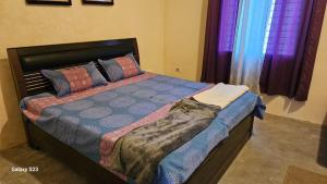 מיטה או מיטות בחדר ב-LDS Homestay