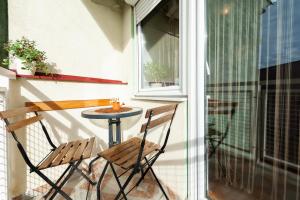 a small table and two chairs on a balcony at Momo's studio apartment Subotica in Subotica