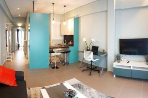 a living room with a couch and a dining room at Cozy apartment close to Acropolis in Athens