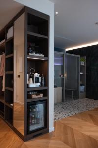 a room with a fireplace in a living room at Savoy Beach Hotel & Thermal Spa in Bibione