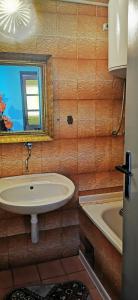 ein Badezimmer mit einem Waschbecken und einer Badewanne in der Unterkunft Lilleheim in Mostar