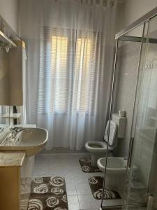 a bathroom with a toilet and a sink and a shower at Casa di Fati in Mestre