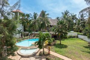 an external view of a villa with a swimming pool at Villa Black Pearl - new private Villa in Diani Beach