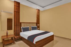 a bedroom with a large bed and a table at Collection O Boutique Heritage House in Allahābād