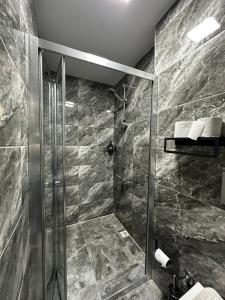 a shower with a glass door in a bathroom at Kubilay Suite in Istanbul