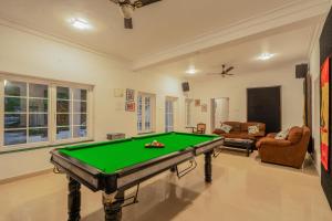 a living room with a pool table in it at Phoenix by Hireavilla 5BR Villa with Pool in Colvale in Colovale