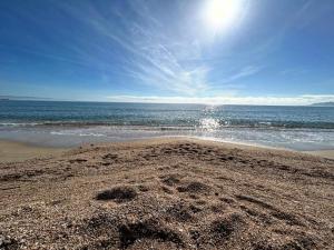 a sandy beach with the ocean in the background at Marina Casa Vacanza in Capoterra