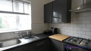 a kitchen with a sink and a stove at Modern en-suite spacious room near Deansgate manchester city in Manchester